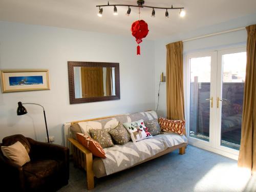 a living room with a couch and a window at The Old Forge, Trafalgar Court in York