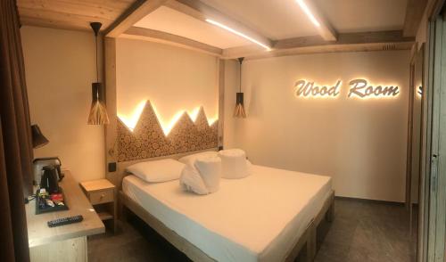 a bedroom with a bed with aoked room sign on the wall at Green Rose in Livigno