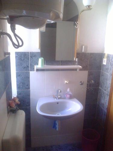 a bathroom with a sink and a toilet at Art House Old Village in Jesenice