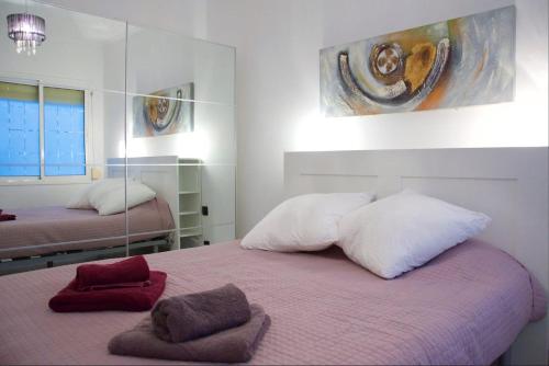 a bedroom with two beds and a mirror at Apartment Sagrera in Barcelona