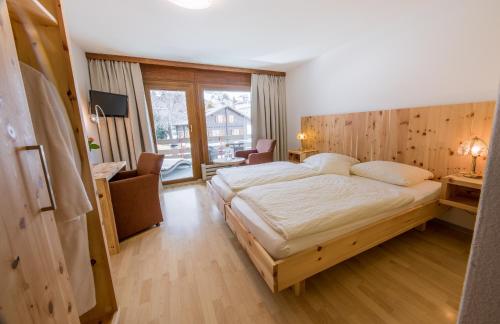 a bedroom with a large bed in a room at Sporthotel Walliserhof in Unterbäch