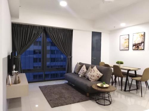 a living room with a couch and a table at Georgetown SeaView Condo Tropicana 218 Macalister in George Town