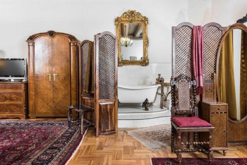 a bathroom with a bath tub and a mirror at Orlowska Townhouse Apartments in Krakow