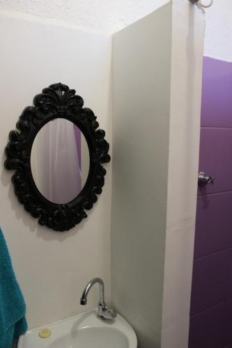 a bathroom with a mirror and a sink at NeighborHUB hostel e coliving in São Paulo