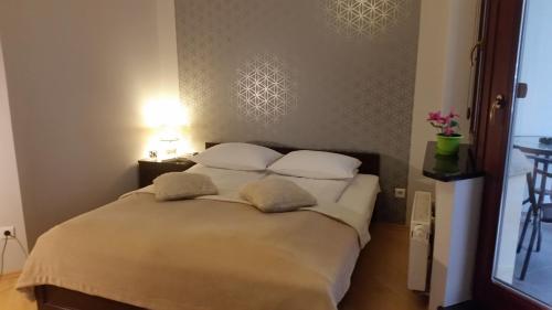a bedroom with a large bed with two pillows at Just Apartments in Wrocław