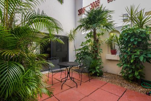 a patio with a table and chairs and plants at Ventura at Boca Raton in Boca Raton