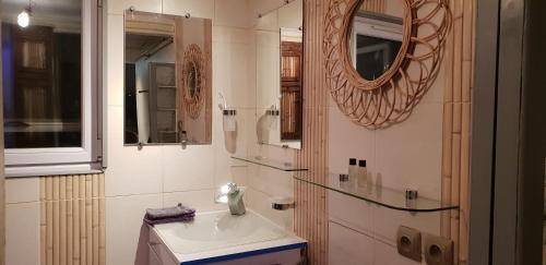 a bathroom with a sink and a mirror at Le Coq de Champagne in Dormans