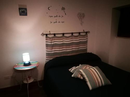 a bedroom with a bed and a lamp on a table at Blue Apartment in Pescara