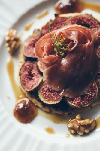 a plate of pancakes with ham and nuts on it at Hôtel Arcé in Saint-Étienne-de-Baïgorry
