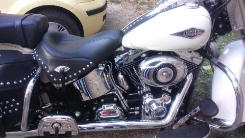 a white and black motorcycle parked next to a car at Corte di Maggio B&B Country House in Imola
