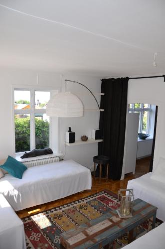 a bedroom with two beds and a coffee table at Villa Trumpetaren in Visby