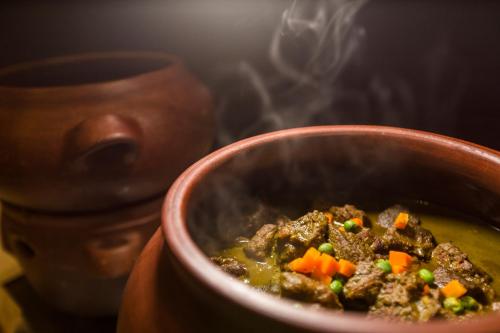 a bowl of soup with meat and vegetables at Delfines Hotel & Convention Center in Lima