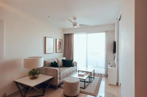 a living room with a couch and a table at Antera Hotel & Residences in Playa del Carmen