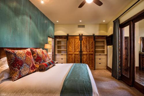 a bedroom with a large bed and wooden cabinets at Gateway Canyons Resort, a Noble House Resort in Gateway