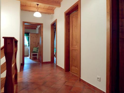 a hallway with wooden doors and a tile floor at Kajzrovka in Rokytnice nad Jizerou