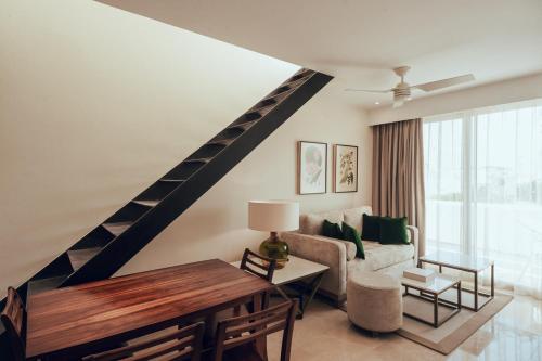 a living room with a couch and a table at Antera Hotel & Residences in Playa del Carmen