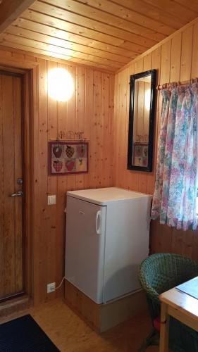 a small room with a washing machine in a cabin at Cozy Cabin in the Woods in Selfoss