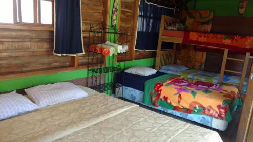 Кровать или кровати в номере HOSTAL CABAÑAS AVE MARIA