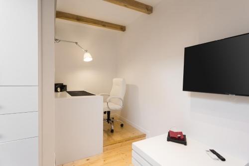 a living room with a flat screen tv on a wall at FIFNY Apartment in Poznań