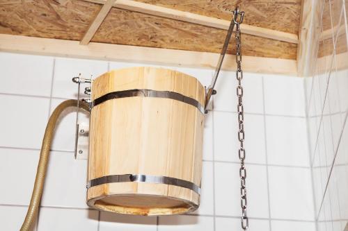 a wooden bucket hanging from a chain in a kitchen at City Backpackers Hostel in Stockholm