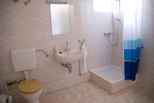 a bathroom with a sink and a toilet and a shower at Haramia Csapszék és Fogadó in Szombathely