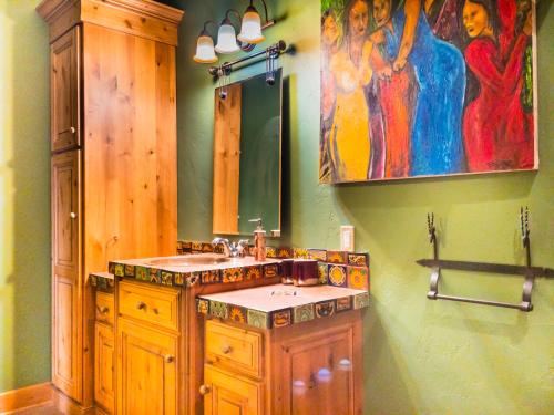 a bathroom with a sink and a mirror at Talus Rock Retreat in Sandpoint