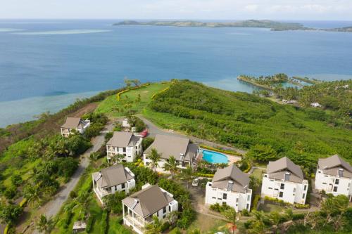 an aerial view of an island with houses and the ocean at Dreamview Villas in Rakiraki