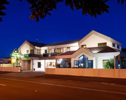 a house on the side of a street at night at Drovers Motor Inn in Palmerston North