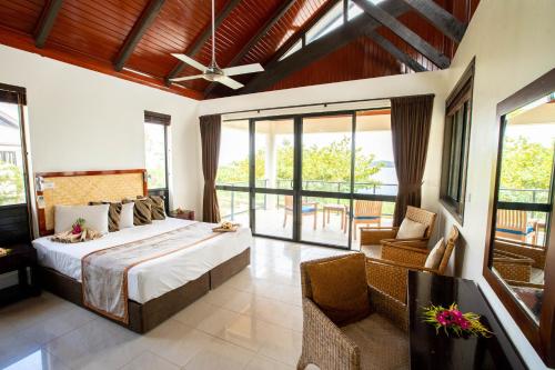 a bedroom with a bed and a balcony at Dreamview Villas in Rakiraki