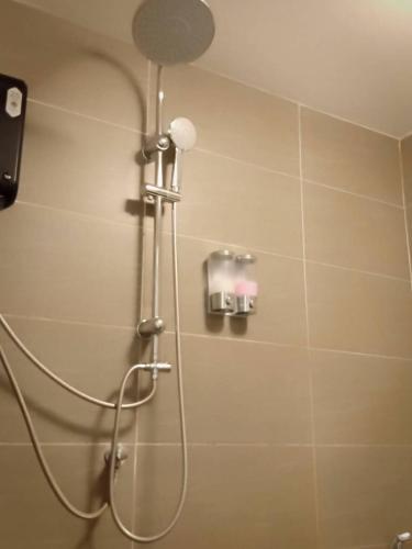 a shower with a shower head in a bathroom at Blue Moon House in Ko Samed