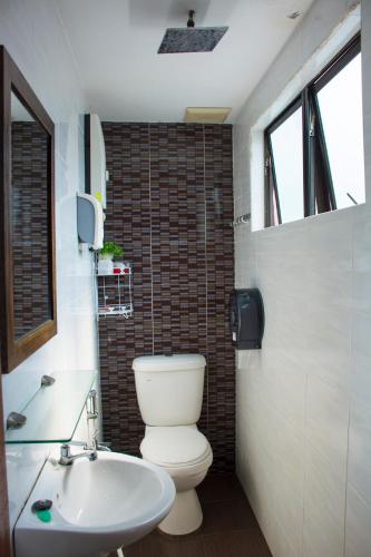 a bathroom with a toilet and a sink at 1511 Guest House in Malacca