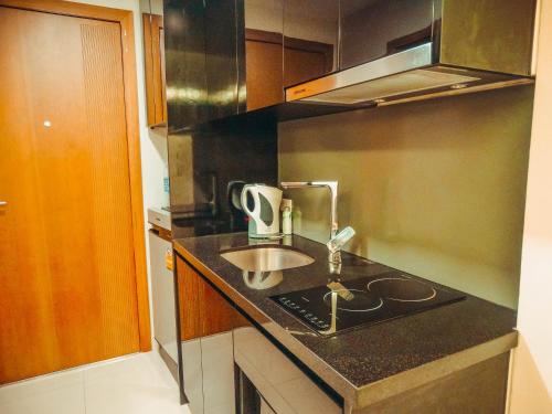 a kitchen with a sink and a counter top at Club Royal suites in North Pattaya