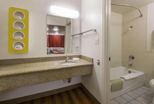a bathroom with a sink and a tub and a mirror at Motel 6-Concord, CA in Concord