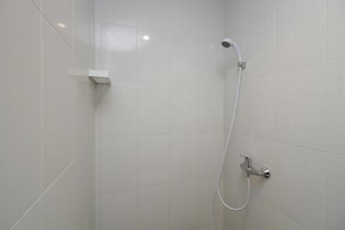 a bathroom with a shower with a glass door at RedDoorz Plus near Plaza Indonesia in Jakarta