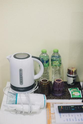 a coffee maker and two bottles of water on a counter at Kristi House in Chiang Mai