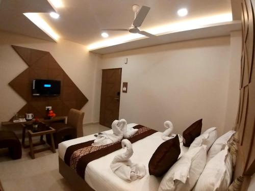 a bedroom with a bed with swans on it at GRAND ELEGANT in Chennai