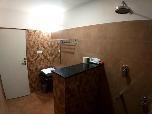 a bathroom with a sink and a toilet in a room at GRAND ELEGANT in Chennai