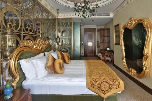 a bedroom with a large bed with golditures at Daru Sultan Hotels Galata in Istanbul