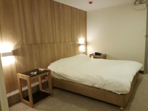 a bedroom with a bed and two night stands at China HK Motel in Hong Kong