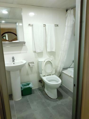 a bathroom with a toilet and a sink at China HK Motel in Hong Kong