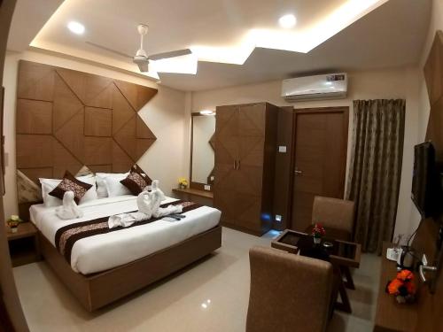 a bedroom with a large bed and a living room at GRAND ELEGANT in Chennai