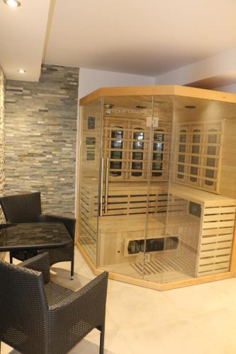 a large wooden cabinet with glass doors in a room at Star Apart Hotel Sachsenhausen in Frankfurt