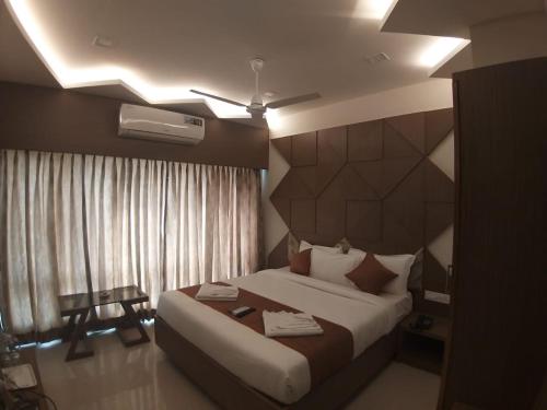 a hotel room with a bed and avertisement at GRAND ELEGANT in Chennai