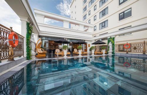 a swimming pool in the middle of a building at Monarque Hotel Danang in Danang