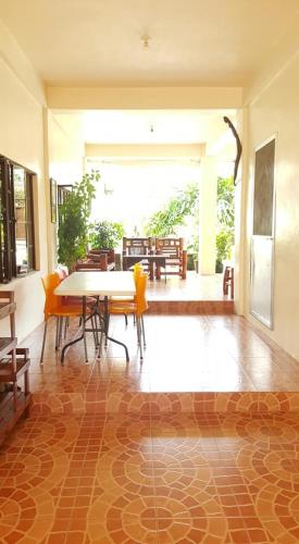 a dining room with a table and chairs on a floor at Sanctuary Transient House in Bacolod