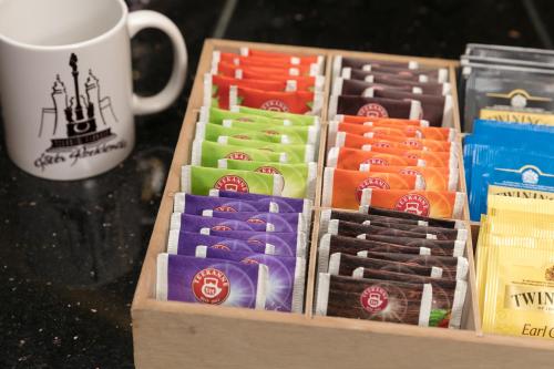 a box of chocolates next to a cup of coffee at Főtér Rezidencia 2 in Győr