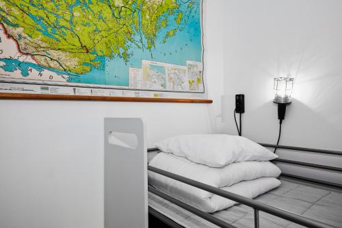 a room with a bed with a map on the wall at City Backpackers Hostel in Stockholm
