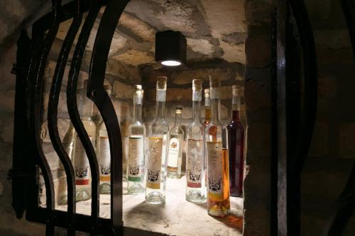 a group of wine bottles in a wall at Főtér Rezidencia in Győr