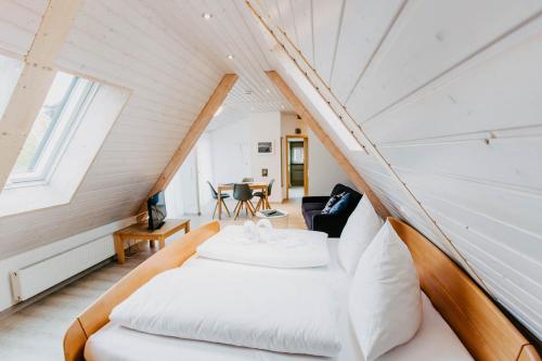 ein Schlafzimmer in einem winzigen Haus mit einem Bett in der Unterkunft Strandpension Mäder in Uhldingen-Mühlhofen