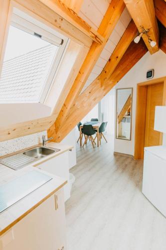 a kitchen and dining room with a skylight at Strandpension Mäder in Uhldingen-Mühlhofen